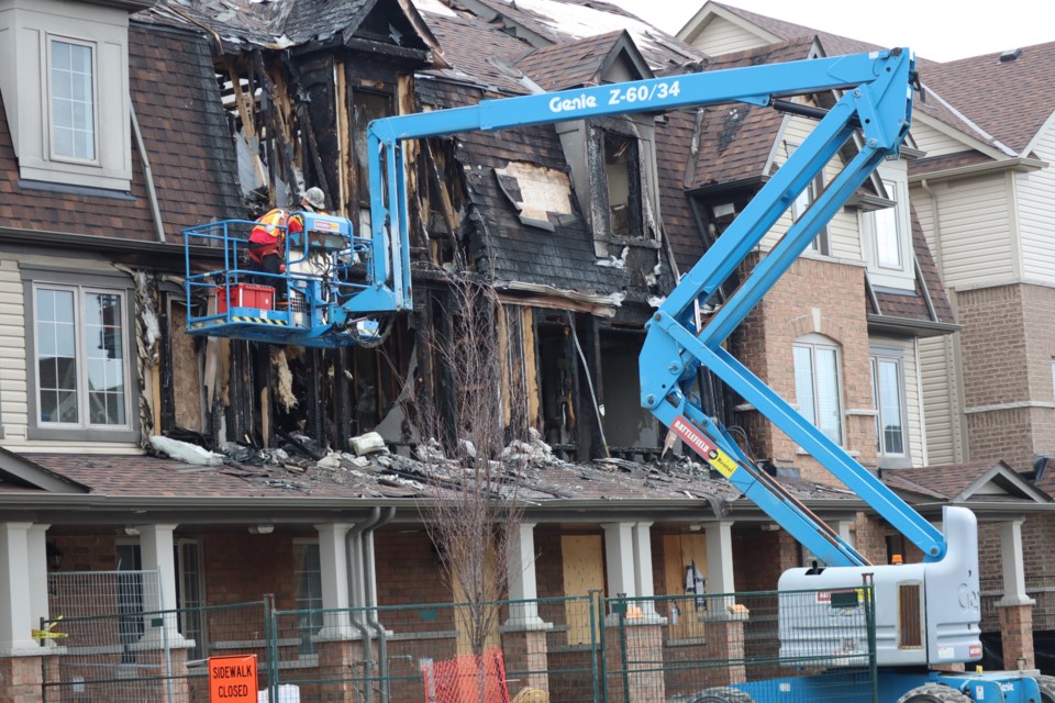 Construction crews demolish the Christmas Day fire home on Linden Drive.