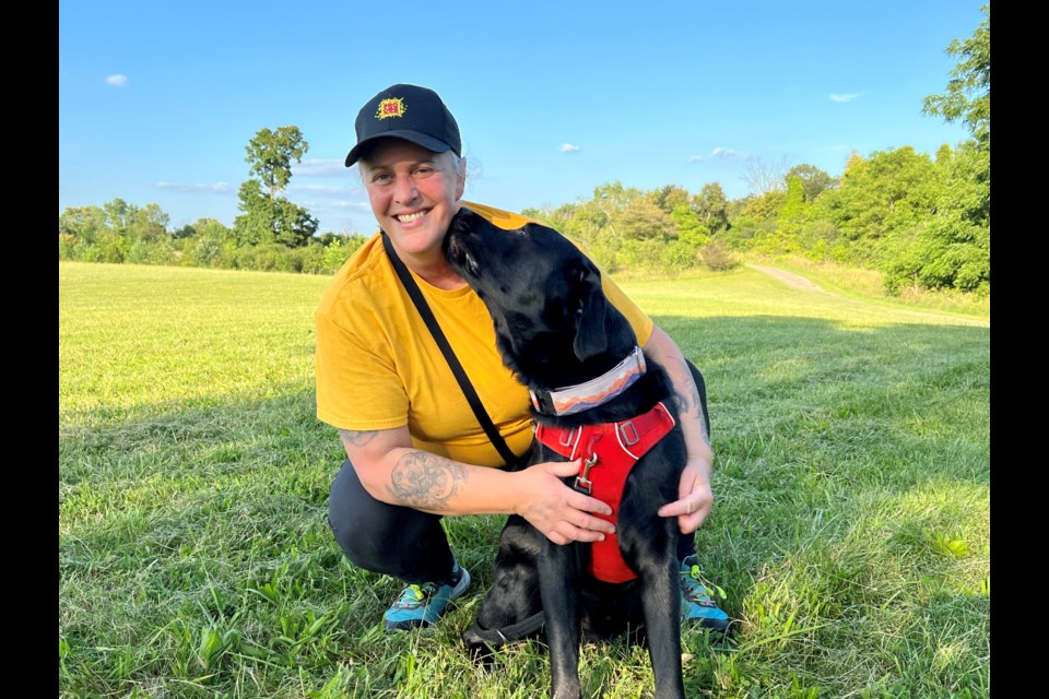 Unleash Clever Canines owner Shannon Nicholson, pictured here with Cormick, hosts free weekly walks in Cambridge parks to teach frustrated dog owners how to improve experiences with their pets.