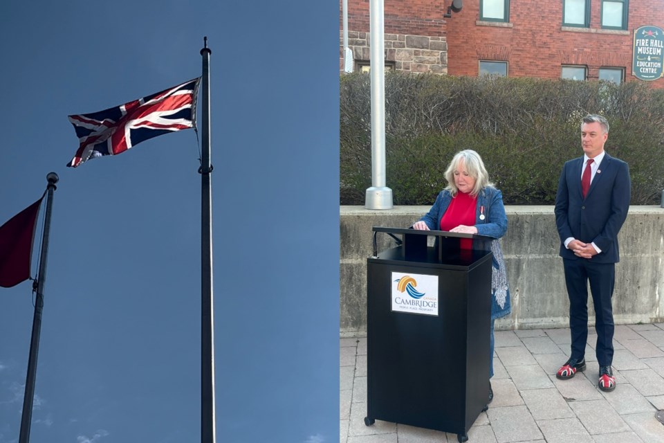 Mayor Jan Liggett and Coun. Adam Cooper address a small gathering at city hall on Saturday morning for the raising of the British flag.