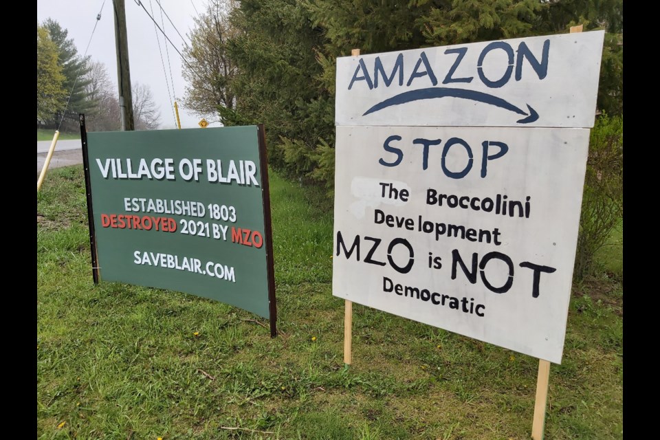 A resident groups has put up signs at the intersection of Dickie Settlement Road and Old Mill Road against the proposed Blair warehouse. 