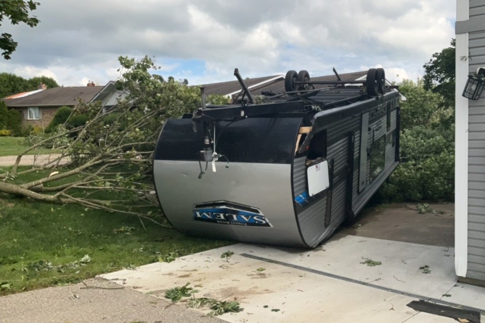 Trailer that was tossed from the neighbouring driveway, taking down and landing on a tree in the process. There was no evidence of sliding or dragging, just a large impact mark in the grass where the trailer landed.