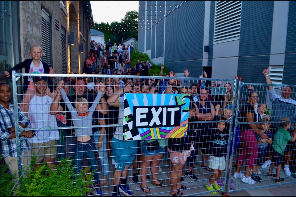 A massive crowd gathers outside the gates at Gaslight District on July 29 after the venue reached capacity inside with 7,000 spectators for the Saturday concert.