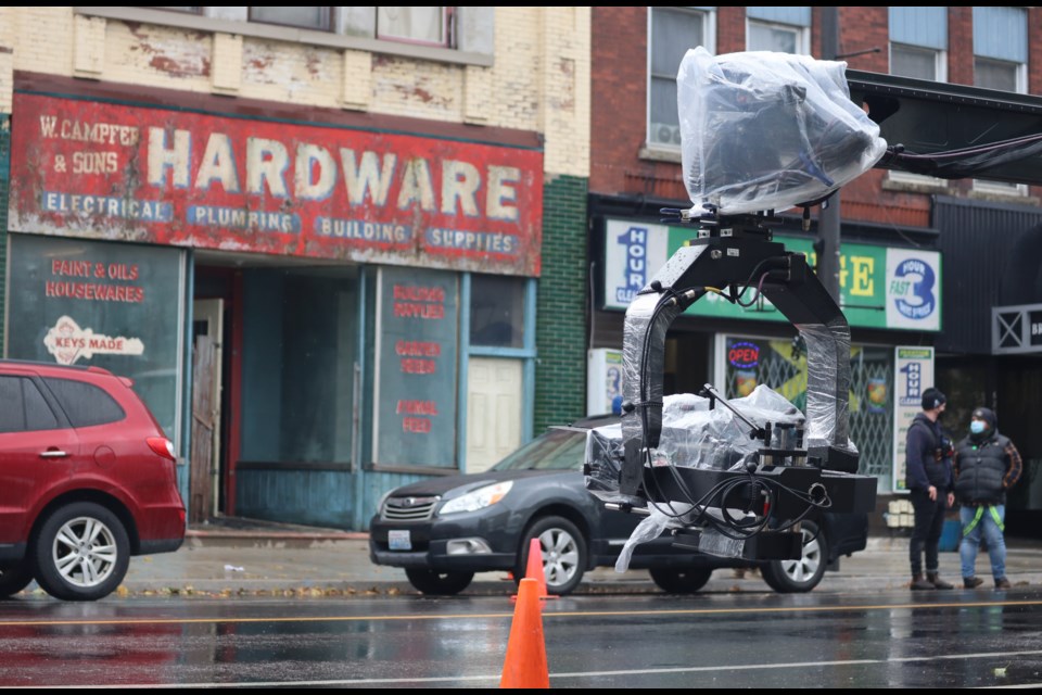 A camera sits on a boom ready to extend across King Street as police set up a brief detour to allow filming on the street Tuesday.