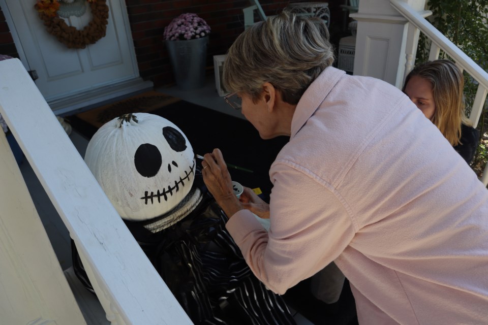 Carolyn and Emily Sutton put the finishing touches on their Jack Skellington jack-o-lantern on Aberdeen Street North. Homeowners in this west-Galt neighbourhood have gone all out this Halloween with many homeowners decorating their homes with pumpkin figures based on a musical theme.
