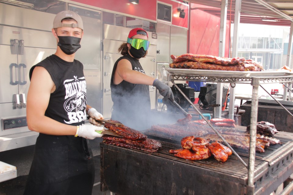 Luke Reddon and Nate Bain, with Billy Bones, were grilling some meats for the Cambridge Rotary Ribfest drive-thru.