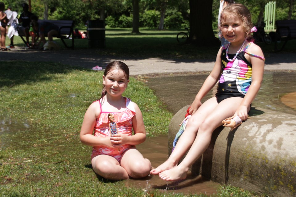 Seven year olds and friends Brittany Felix, of Kitchener and Jewels Novak-Marote, of Cambridge visited the Riverside Park splash pad with their Barbies.