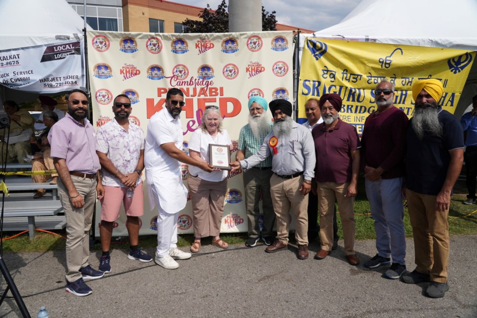 Cambridge Mayor Jan Liggett joins organizers of the Punjabi Sports Fair.