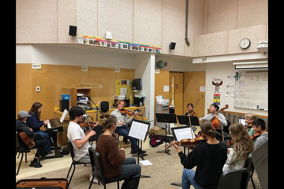 The Coast String Fiddlers rehearse under the interim directorship of Simon Gidora.