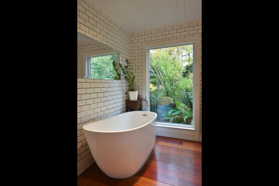 The newly renovated master bathroom, with a modern tub replacing the ancient, cold clawfoot.