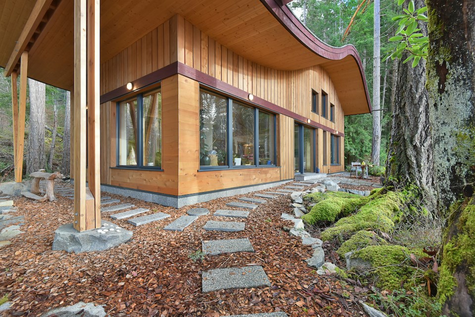 The roof ripples over this architect-designed Sunshine Coast home.