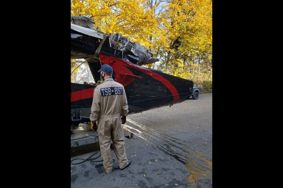 A Transportation Safety Board investigator and the K-1200 helicopter wreckage at the TSB hangar in Richmond.