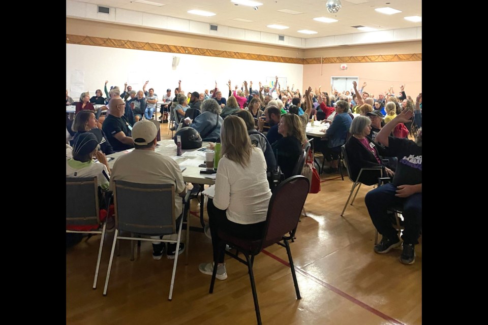 Victims of crime raise their hands at a meeting on crime and safety in Sechelt, Aug. 21