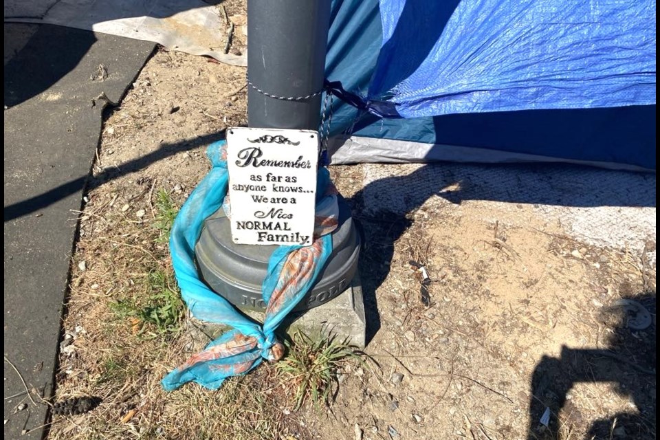 A humorous sign in front of a shelter in the tent city on Hightide Avenue.