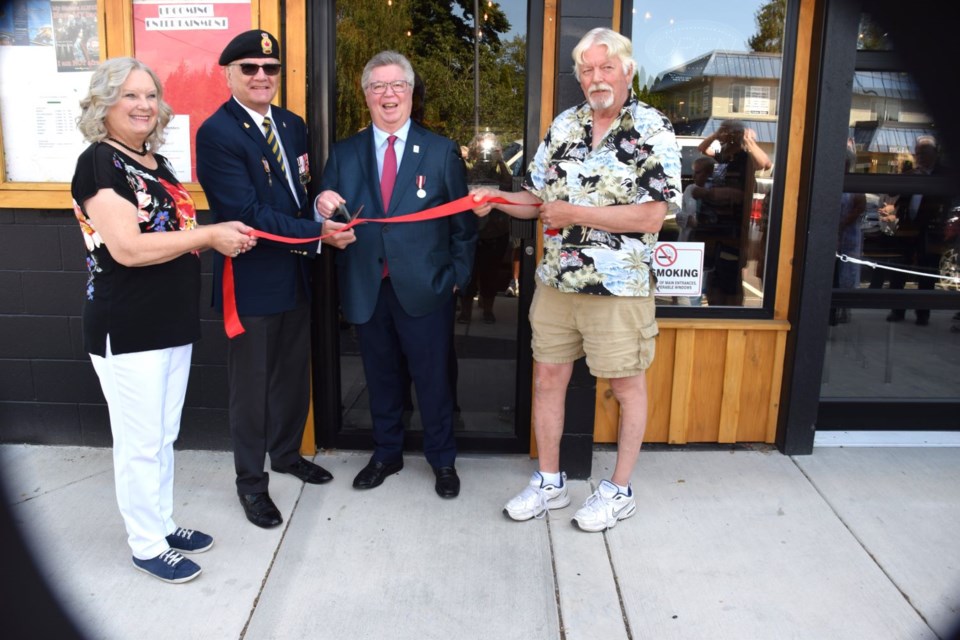 Sechelt Legion board member Suzanne McLean, president Bill McLean, Sechelt Mayor John Henderson, and member Mike David cut the ribbon on the new home to Branch 140 of the Royal Canadian Legion on Inlet Street, July 26. Mike David volunteered hundreds of hours of his time in completing the woodwork in the new building. 