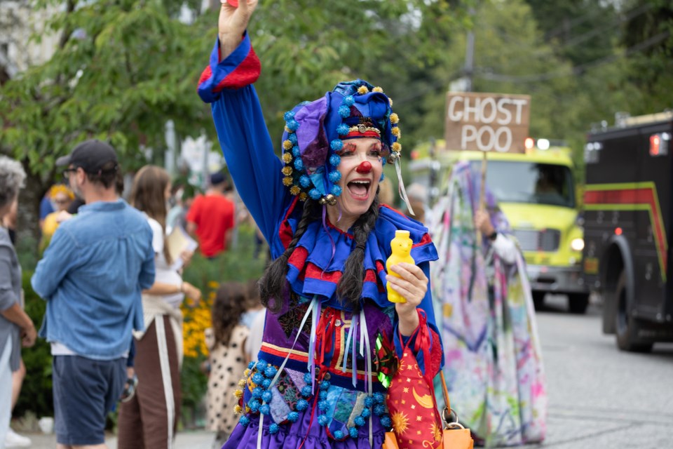 Clowns and stilt-walkers danced to music.