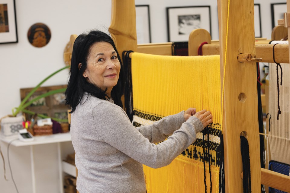 Jessica Silvey, keeping a watchful eye on the workshop, weaves traditional and contemporary cedar bark baskets, hats, mats, Salish blankets and throw pillows using wool dyed with traditional food and medicine plants.