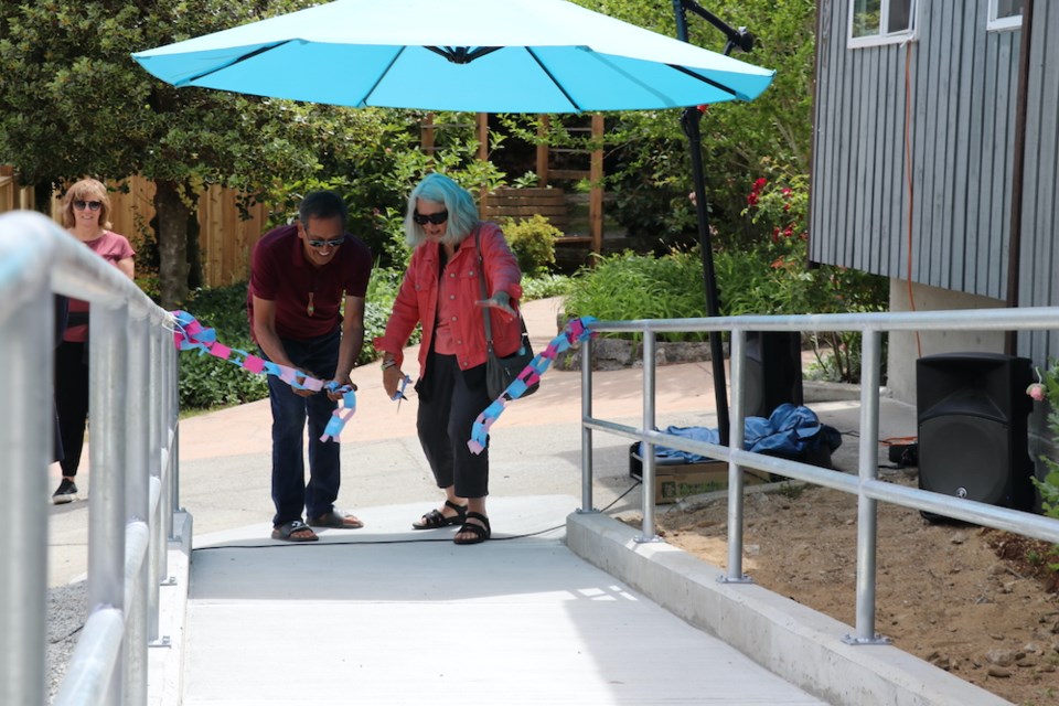 hiwus (Calvin Craigan) and SCACL board chair Pat Feindel cut the ribbon for the Rosecliffe Staff Supported Home's new accessible ramp. 