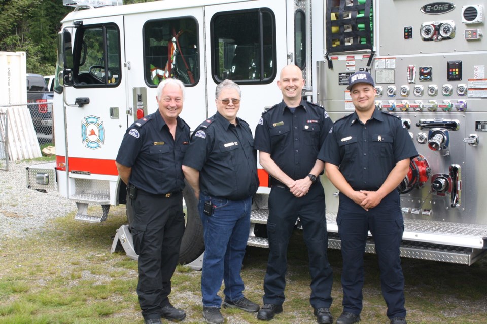 Graham Webb, 
Mike Costa, Mike Cupit and Ryan McDonald, firefighters with the Gibsons and District Fire Department, let the kids check out the fire truck and try on their heavy duty safety gear.