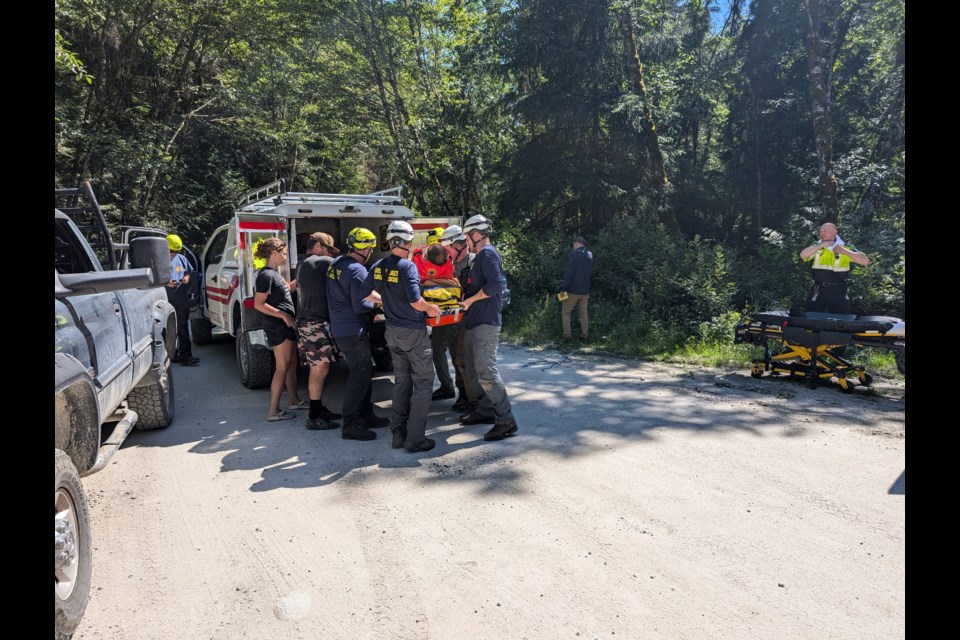 Search and rescue crews transported the injured mountain biker to one of their trucks, who brought them to the ambulance. 