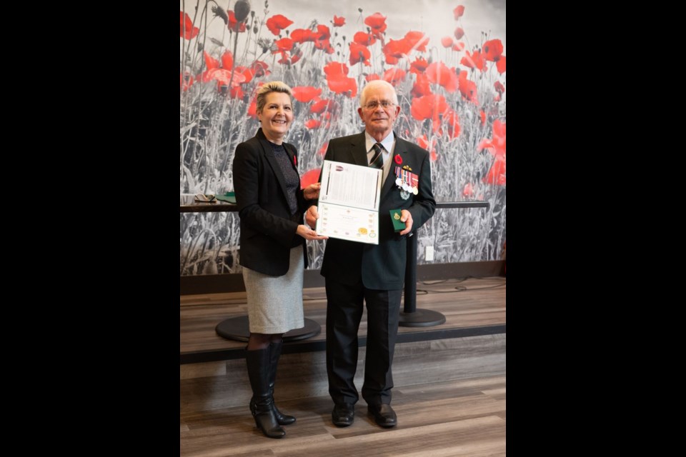 MP Bonita Zarrillo presenting the King Charles III Coronation Medal to retired Col. Keith Maxwell. 