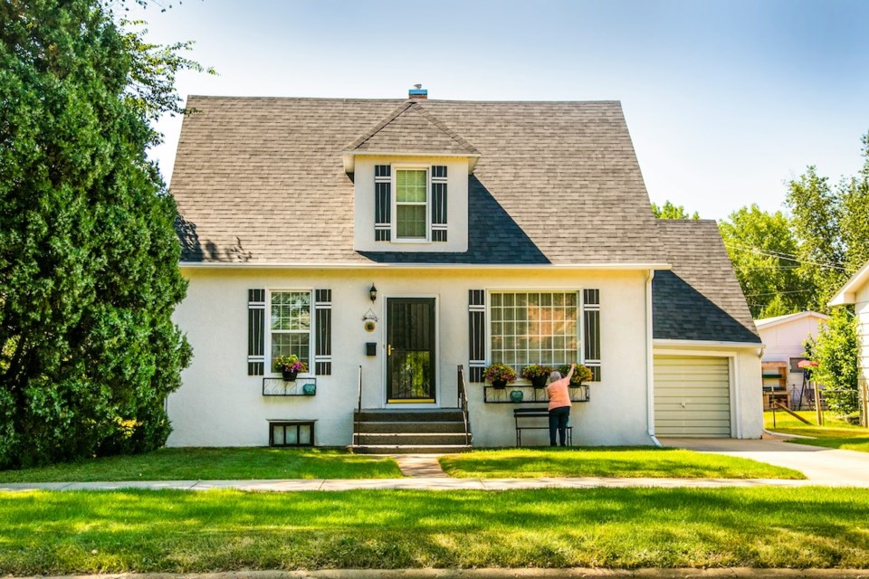 house-and-sunny-yard-woman-in-front