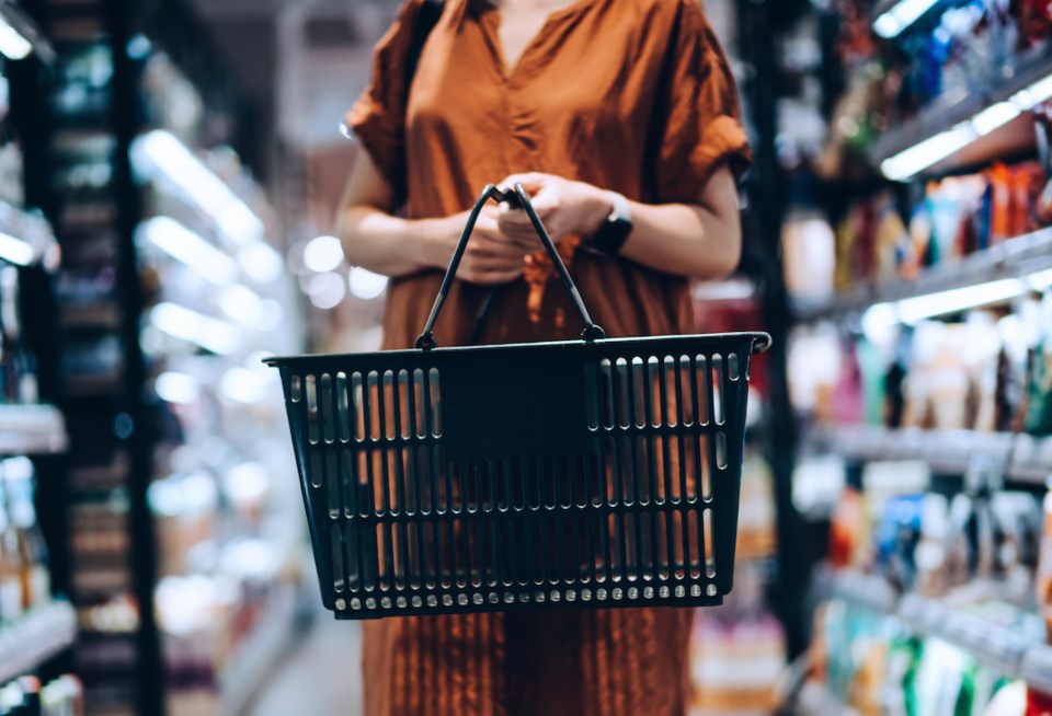 Person carrying an empty shopping basket