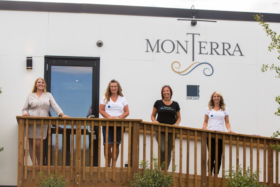 Aspen Creek Designer Homes chief design junkie Stacey Rivett, left Kendra Watt Real Estate administrator Sylvia Hendsbee, realtor Kendra Watt and realtor Dawn Park host an open house at the Monterra Discovery Centre on Monday (Aug. 17).(Chelsea Kemp/The Cochrane Eagle)