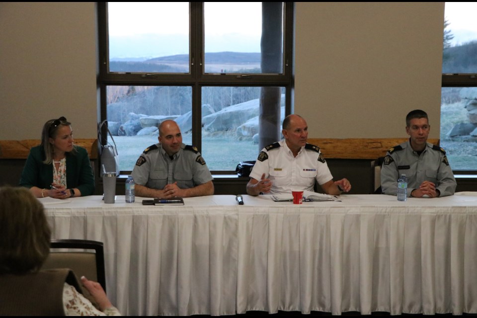 Cochrane RCMP office manager Bethany Hoskin, left, Sgt. Jeff McIntosh, Inspector Dave Brunner, and Staff Sgt. Chad Fournier talk community policing at an RCMP town hall at the RancheHouse April 27. (Jessica Lee/The Cochrane Eagle)