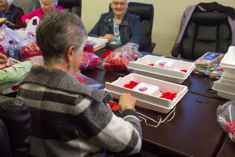 The Ladies Auxiliary Royal Canadian Legion no. 15 prepare poppies ahead of Remembrance Day at the Cochrane Legion on Oct. 19.