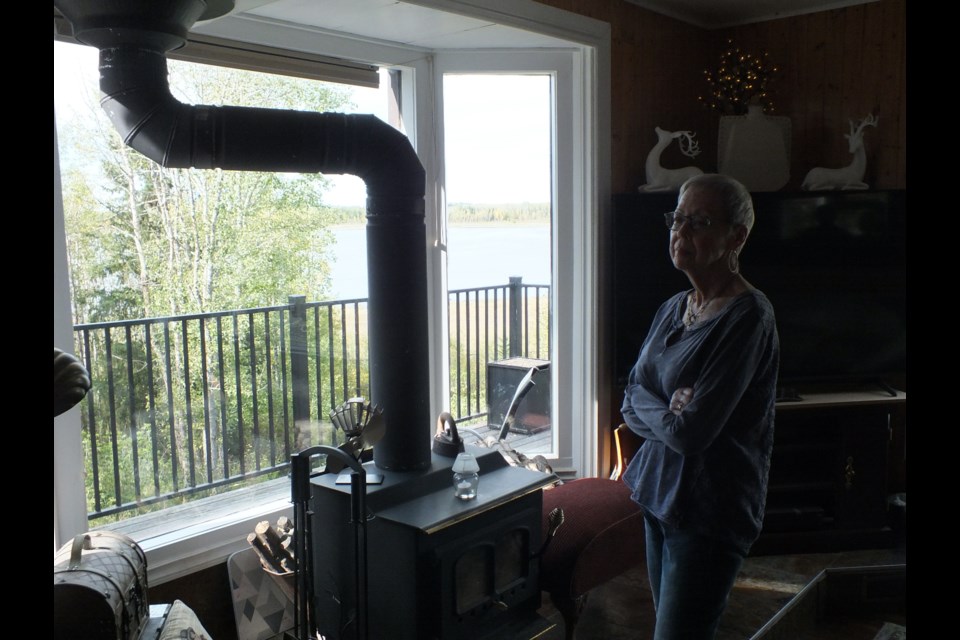 Charlene Needham gazes out her living room window.