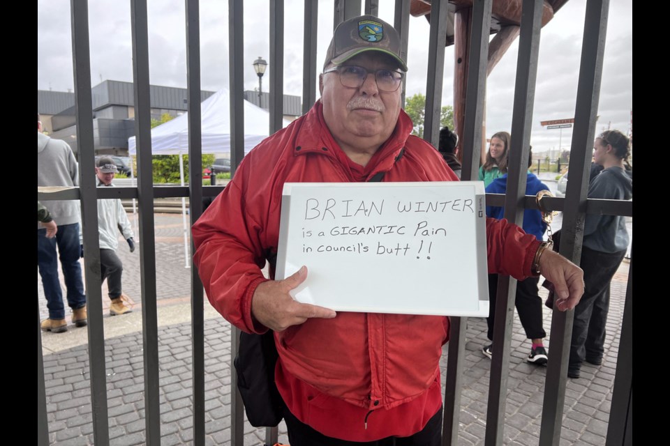 Cochrane Seniors for Kids Society ran their first Jail N Bail fundraiser in the rain in Centennial Plaza Friday, Sept. 20. (Pictured): Brian Winter stood accused of being a “pain” and former mayor Judy Stewart of stretching the truth about her reign. Both had to raise $150 ‘bail’ before being released.