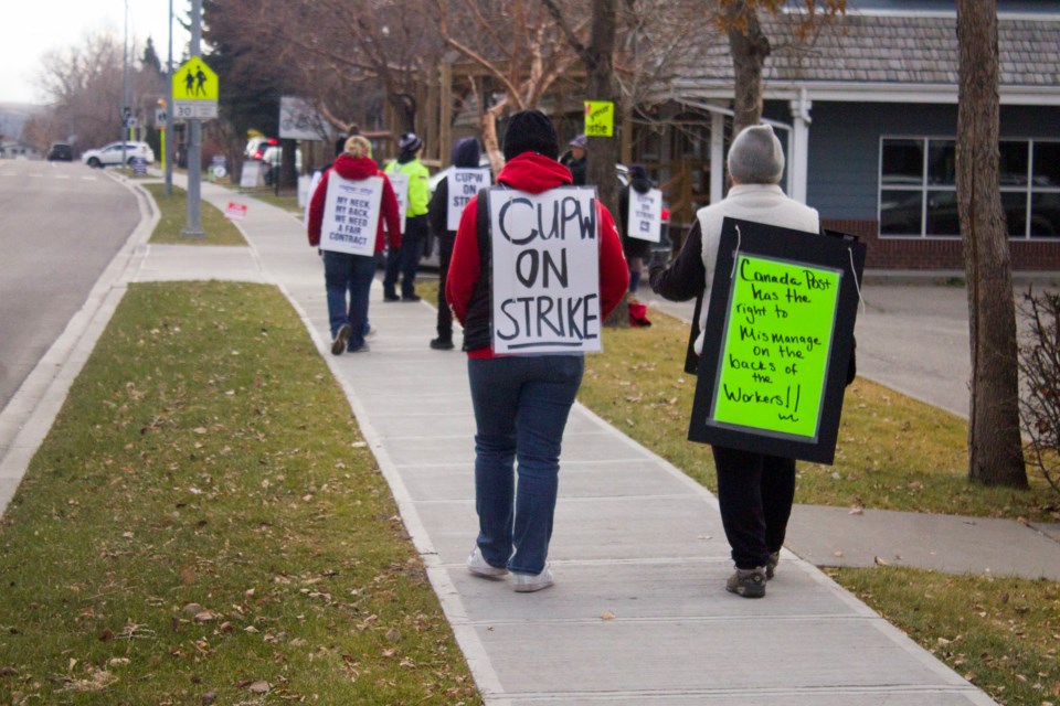 Postal workers gathered outside of the Cochrane Main Post Office on 125 1st St. as part of the nationwide strike of Canada Post workers that officially started on Nov. 15.