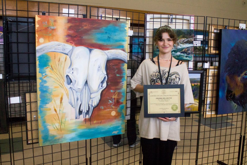 Bow Valley High School graduate Orianna "Ori" Millwater with her award winning piece "Echoes of the West."