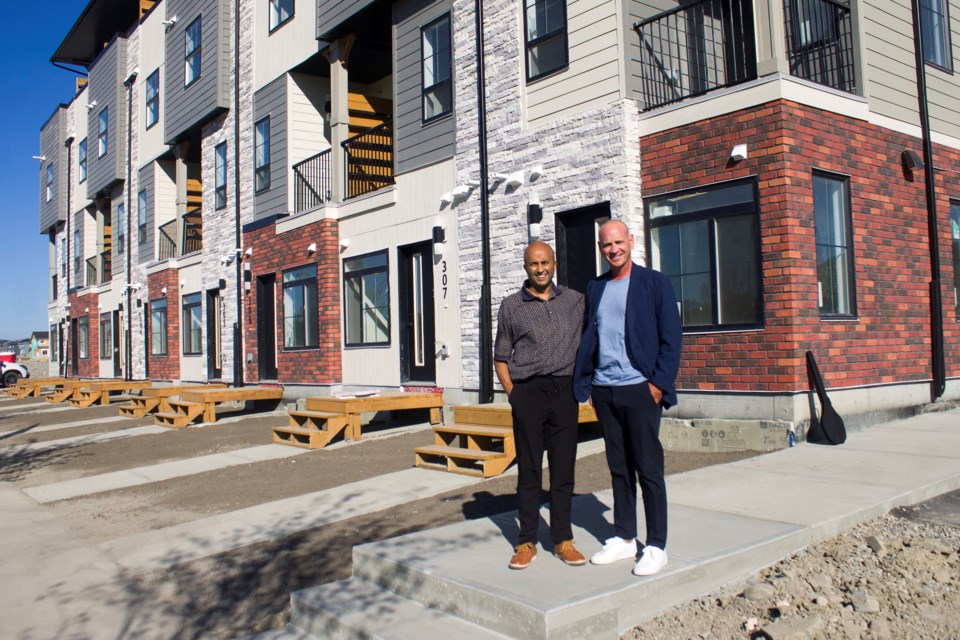 (Left to right) Harish Consul with Mayor Jeff Genung outside of the first Vertos building in the upcoming community of Greystone.