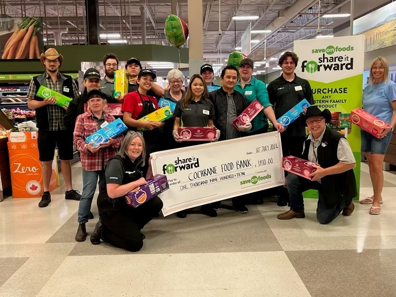 Photo submitted by Kathie Ratico of the team at Cochrane Save On Foods holding up the cheque to be donated to the Cochrane Food Bank.