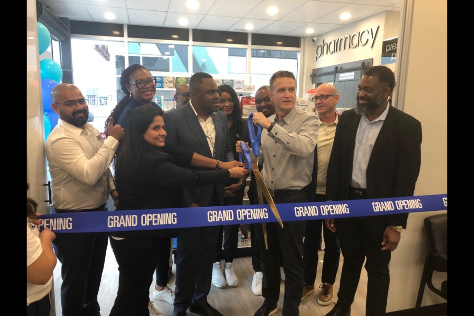 Peter Guthrie does the honours at the ribbon-cutting ceremony of Griffin Road Medical Clinic, a state-of-the-art family practice and walk-in facility, last Friday. Dr. Uche Nwadike is the Medical Director.