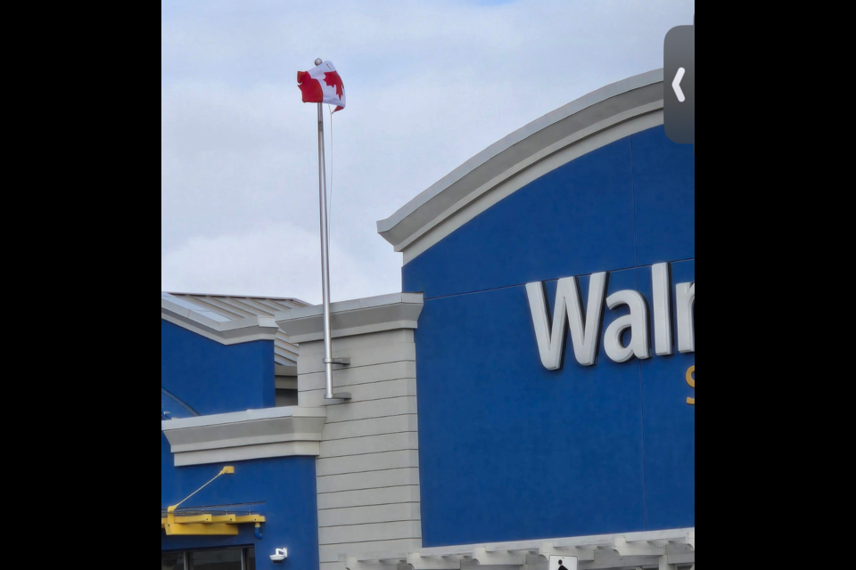 The flag seen flying upside-down outside of the Cochrane Walmart.