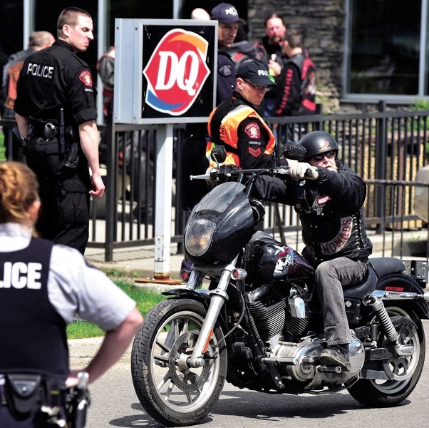 A police officer monitors motorcyclists at the Dairy Queen in Cochrane.