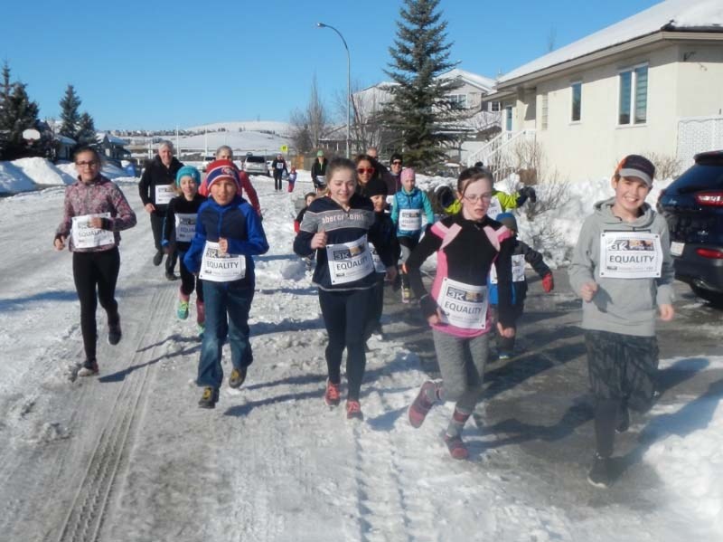 Martin Parnell holds up the bib that he wore during the first Secret Marathon at Ecole Notre Dame.