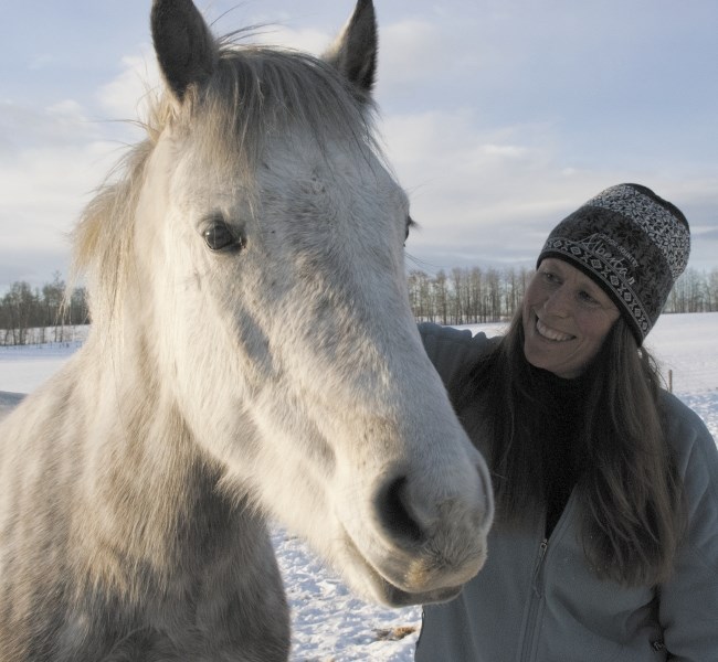 Healing Hooves owner Sue McIntosh of Cremona gives Finnegan a pat.