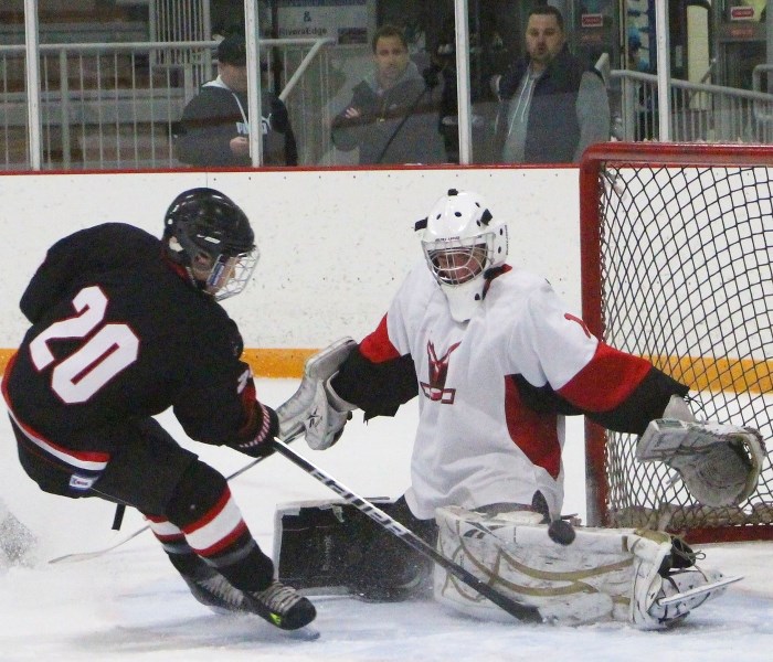 Bow Valley Timberwolves forward Bradley Lizon shovels the puck at Airdrie Lightning goalie MacAulay Carefoot in Game 2 of Midget AA provincial qualifying play Jan. 24 at