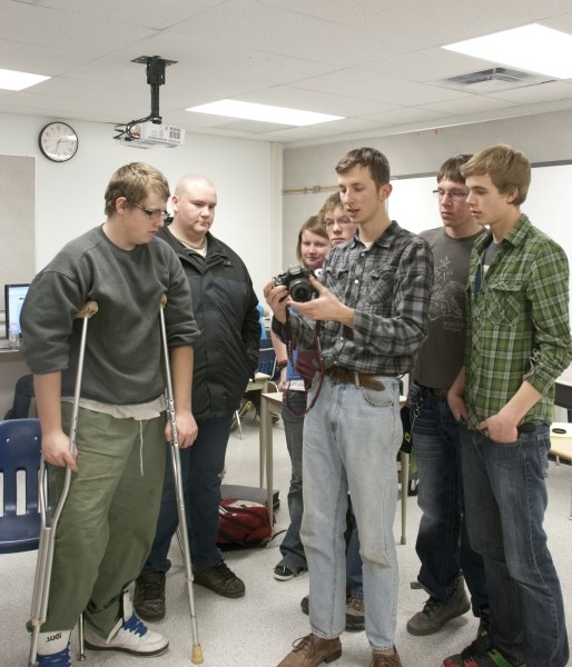 Canadian Frame(lines) filmmaker, Ryder White, shows Cremona School students Chris Pederson (left), Alex Proctor, Jacey Fairs, Brayden Kulscar, Cory Michaud and John King how