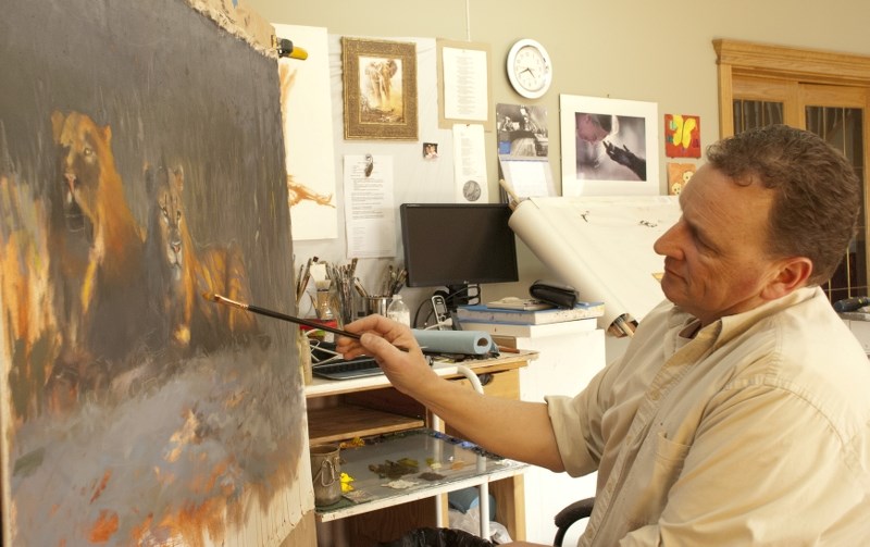 Hermann Brandt works away on a painting in his Clear Air Art Studio on April 18.