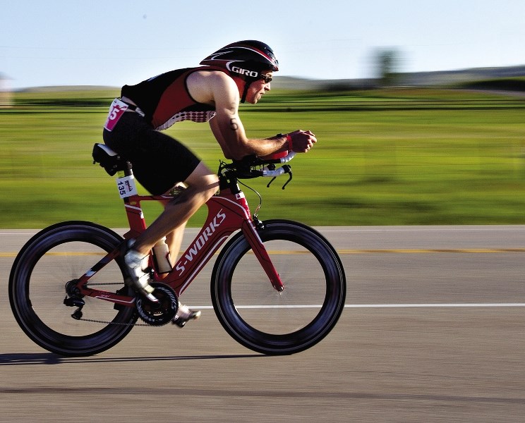 Mark Mundell, from Lethbridge, races east on Highway 1A during the Ironman 70.3 Calgary race in 2012. The race will use a different route this year, but will travel through