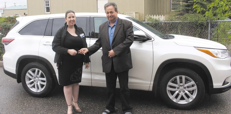 Sarah Owen, project administrator for Cochrane Victims Services, gets the keys to Victim Services&#8217; new vehicle from Jeff Decter, sales and finance specialist with