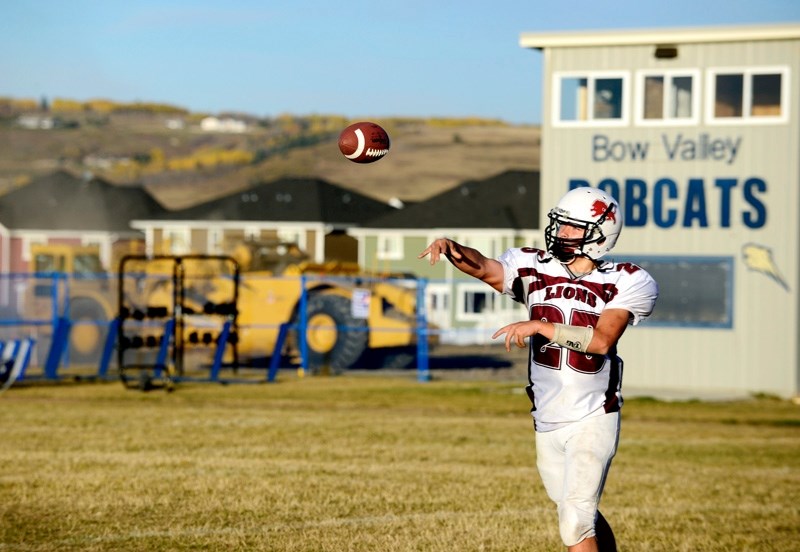 Cochrane Bantam Lions quarterback Jackson McLean heaves a pass during team practice Oct. 9 at Bow Valley High School&#8217;s Stewie Devlin Field. Heavy machinery in the