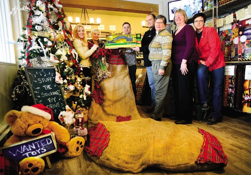 Ghost Station owners Corleen Schultz and Mike Mondor receive donations from Cherie Vermeulen, Ryan McKay, Sue Schott, Donna Tons and Caroline Hookey at the Ghost Station Nov. 