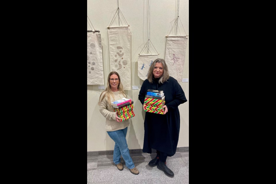 Lyndsay Boyce , left, and Alex Robbinson of the Collingwood Public Library are hosting Saturday's book sale and makers' market where they'll also be selling wrapped mystery packages. Contributed image