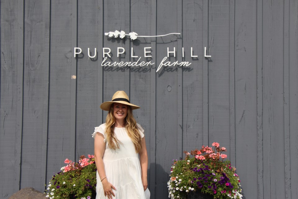 Emma Catton stands in front of her mom's old horse barn, which has been converted into the main entrance and retail store at Purple Hill Lavender Farm. Maddie Johnson for CollingwoodToday