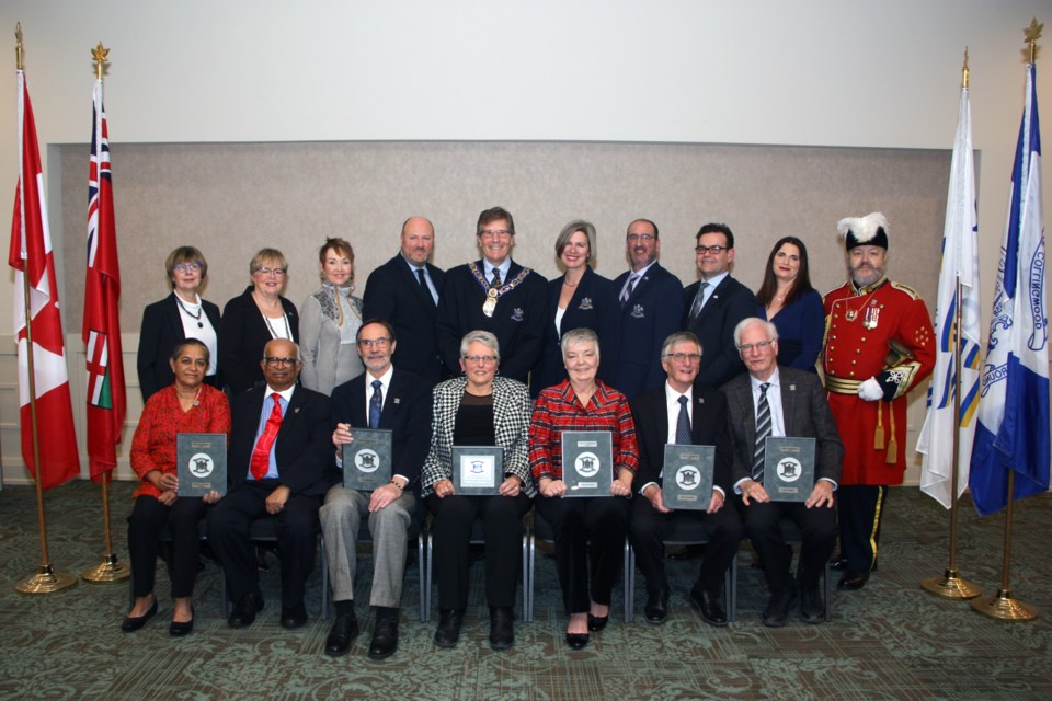 Collingwood council with the 2020 Order of Collingwood recipients. Back row from left: Coun. Yvonne Hamlin, Coun. Kathy Jeffery, Coun. Deb Doherty, Deputy Mayor Keith Hull, Mayor Brian Saunderson, Coun. Mariane McLeod, Coun. Steve Berman, Coun. Bob Madigan, Coun. Tina Comi, Town Crier Ken Templeman. Front row from left: Shashi and Eswar Prasad, Ron MacRae, Marilyn King-Lawrence (Companion to the Order), Barbara Sharp, David Saunders, and Larry Hogarth. Erika Engel/CollingwoodToday